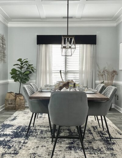 An elegantly set dining room with a neutral color palette and modern decor.